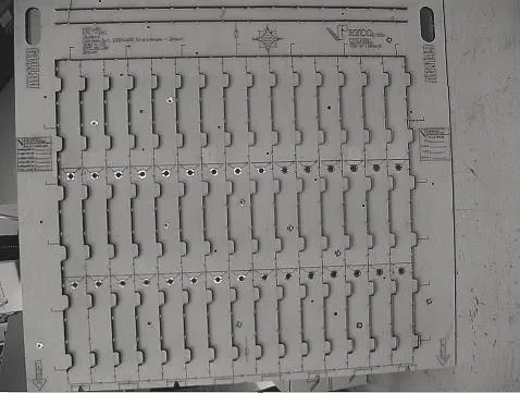 Flat forme die board laid out with rows of cutting rules, the Ryco mark etched in one corner